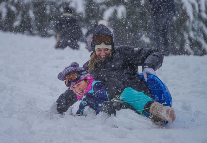 Mom and child play in NYC snow