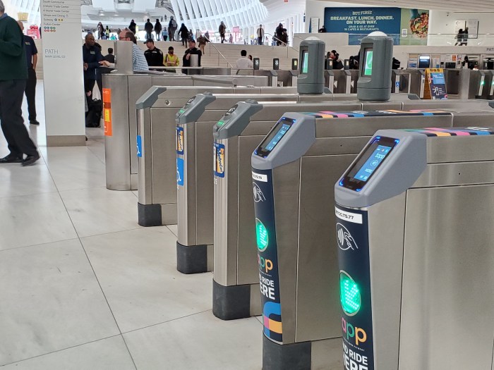 A row of turnstiles at the Oculus with TAPP and MetroCard/SmartLink fare arrays