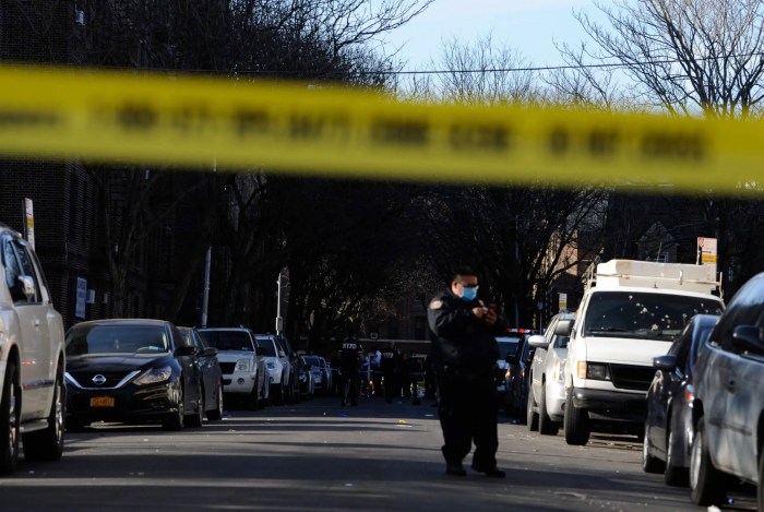 Police officer with crime scene tape up