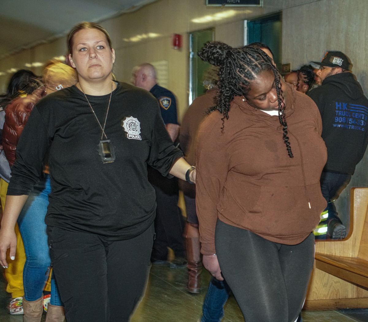 A woman arrested in a ghost gun and fraud bust on March 7, 2024 is escorted into a Manhattan Criminal Court room