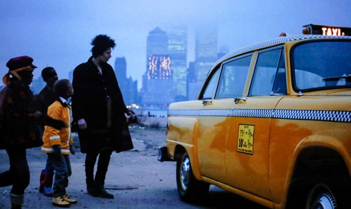 New York City skyscrapers graze the skyline as Sid Vicious, played by Gary Oldman in "Sid and Nancy" (1986), grabs a yellow taxi in Jersey City