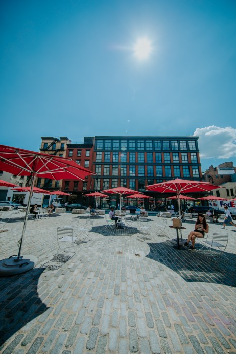 a series of open red umbrellas in the Meatpacking District