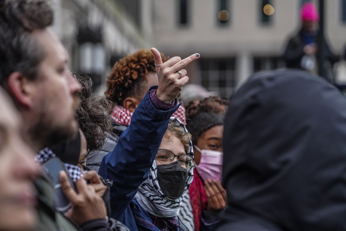 Thousands looked on in fury, booing and chanting “No pigs on campus.