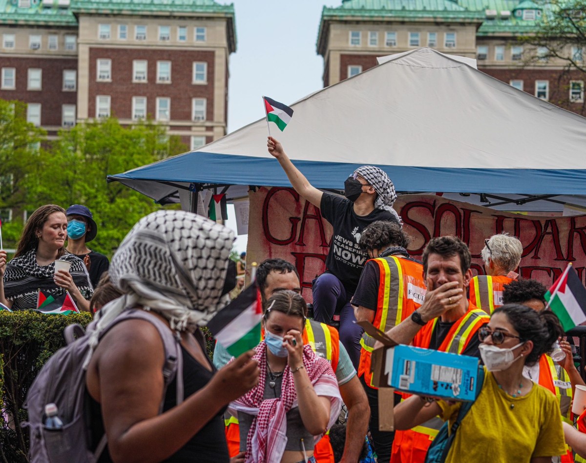 Faculty and staff interlocked their arms and formed a human barricade at the entrance to the tent site.