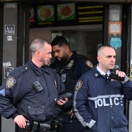 NYPD officers talking on a radio