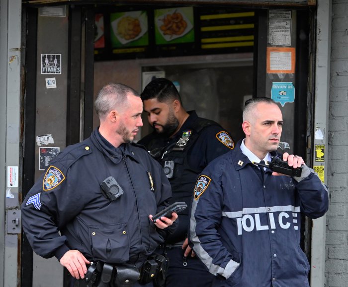 Police officers talking on a radio