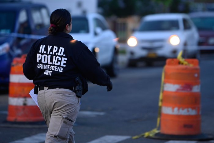 crime scene detective in the early morning hours investigating shooting in Queens