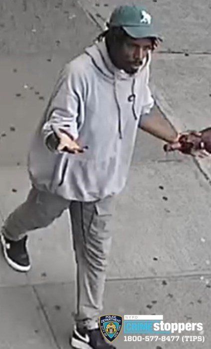 photo of perp accusing of hitting women in Brooklyn wearing baseball hat and light-colored sweatshirt