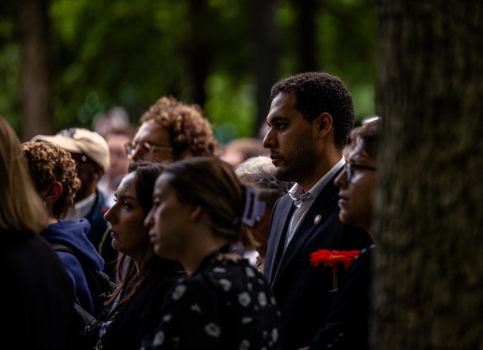 people at a ceremony looking somber 
