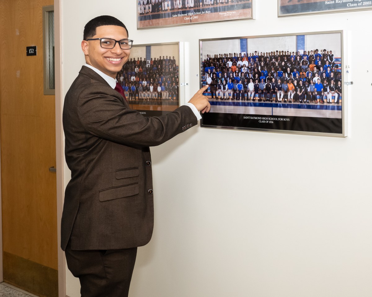 NYPD Detective Angel Familia points to his class photo. Photo by Gabriele Holtermann