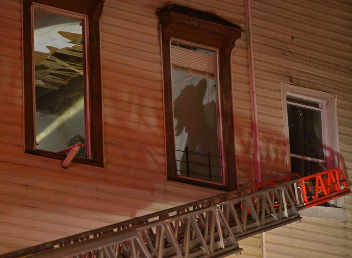 Silhouette of Brooklyn firefighter battling blaze