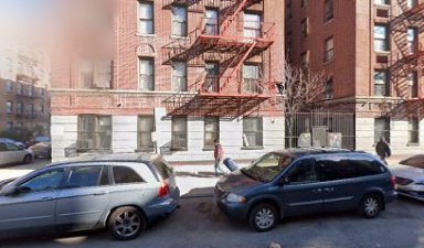 building in the Bronx with two cars parked in front, outside of which a deadly shooting occurred