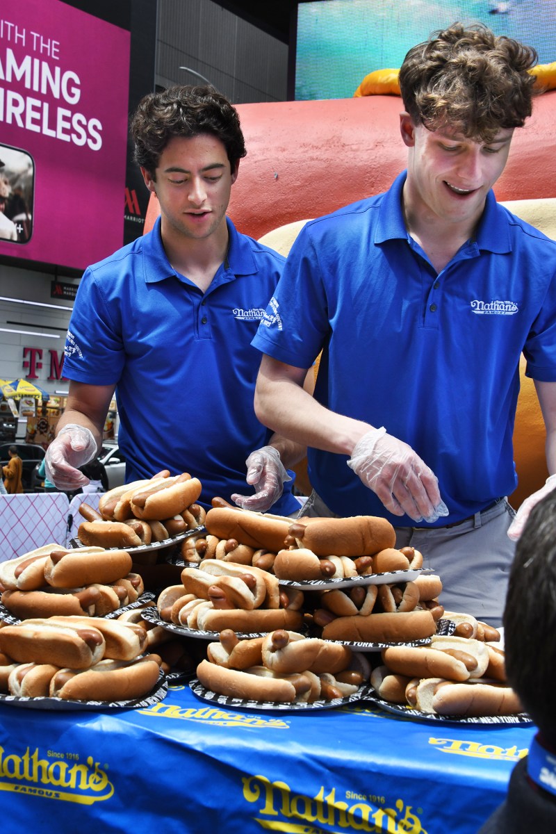 Two boys Getting the hot dogs ready for the contest