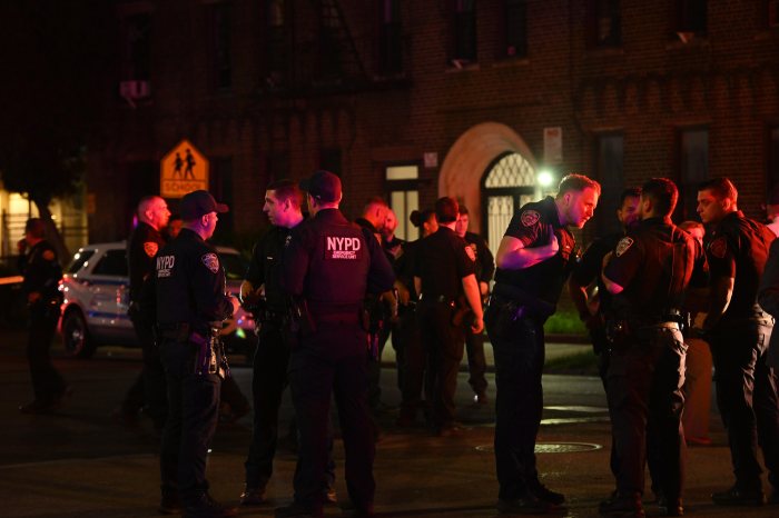 NYPD officers at a crime scene at night in Brooklyn