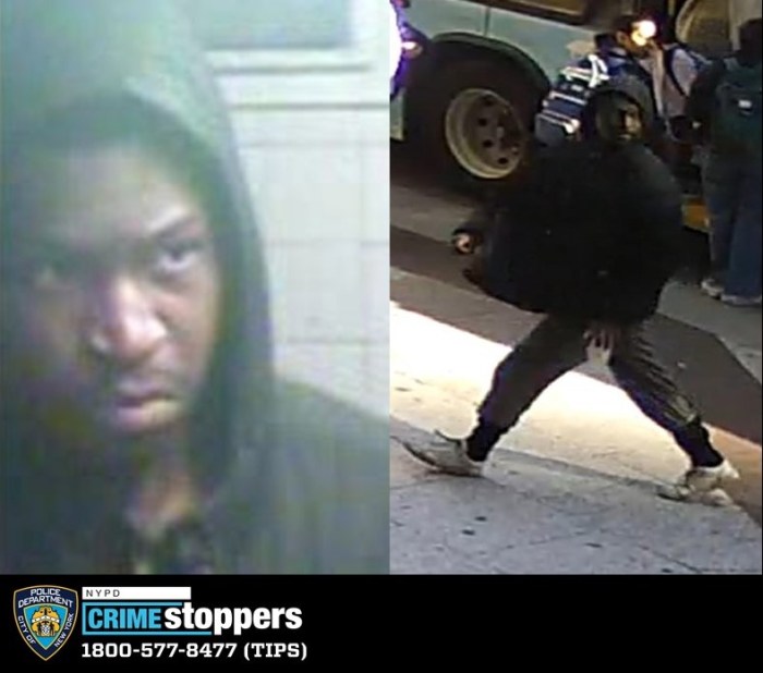 suspect wearing mostly black walking on a sidewalk wanted for assault in Manhattan