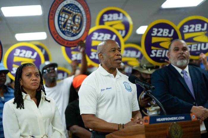 Mayor Adams announces community hiring initiative in front of 32BJ union members holding signs
