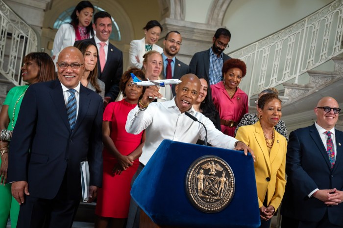 Mayor Eric Adams holds plane during NYC budget deal announcement
