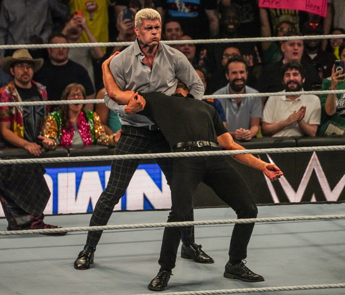 Cody Rhodes attacks a security guard