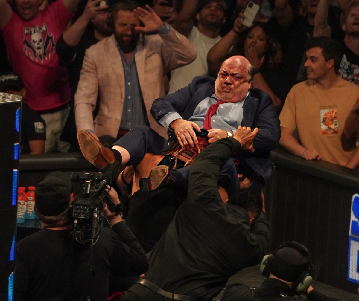 Paul Heyman is power bombed through a table