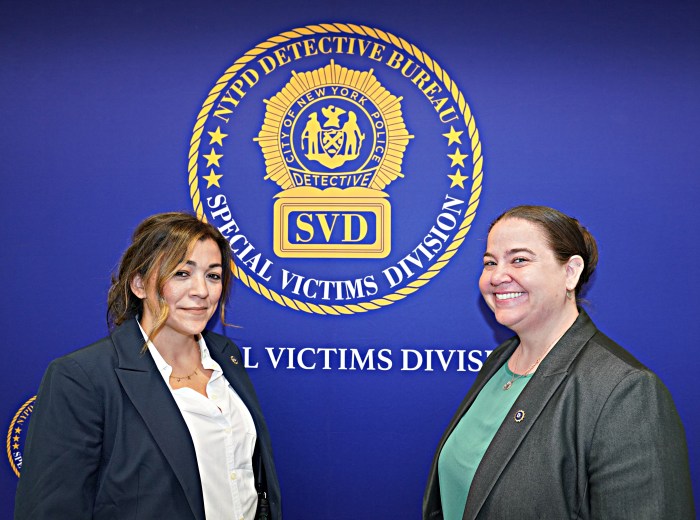 NYPD Special Victims Detectives in front of bureau logo