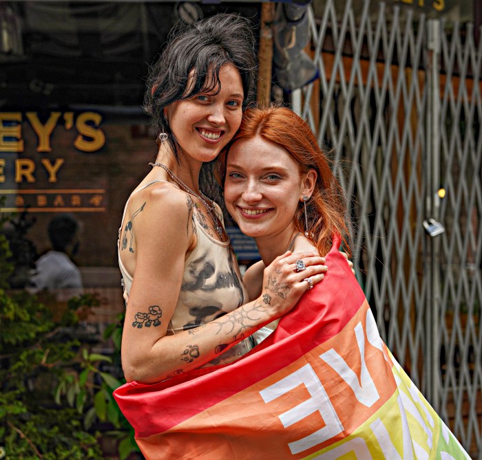 Women embrace at NYC Pride March