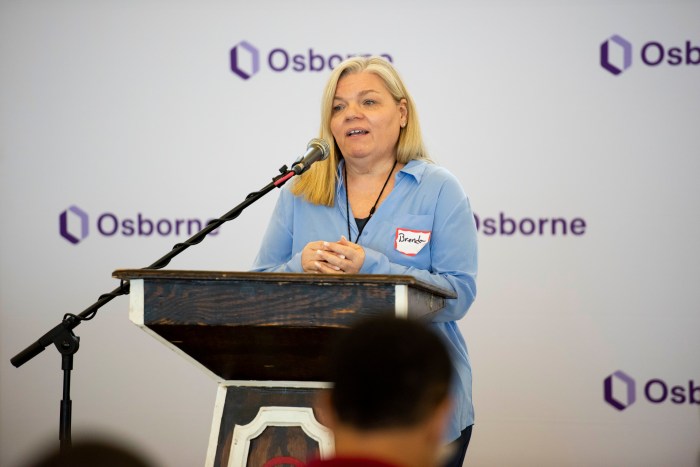 woman wearing blue speaking at a podium