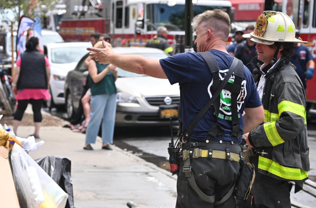 A Firefighter and Battalion Chief review the firefighting operations following a fire at 3067 Brighton 3rd Street