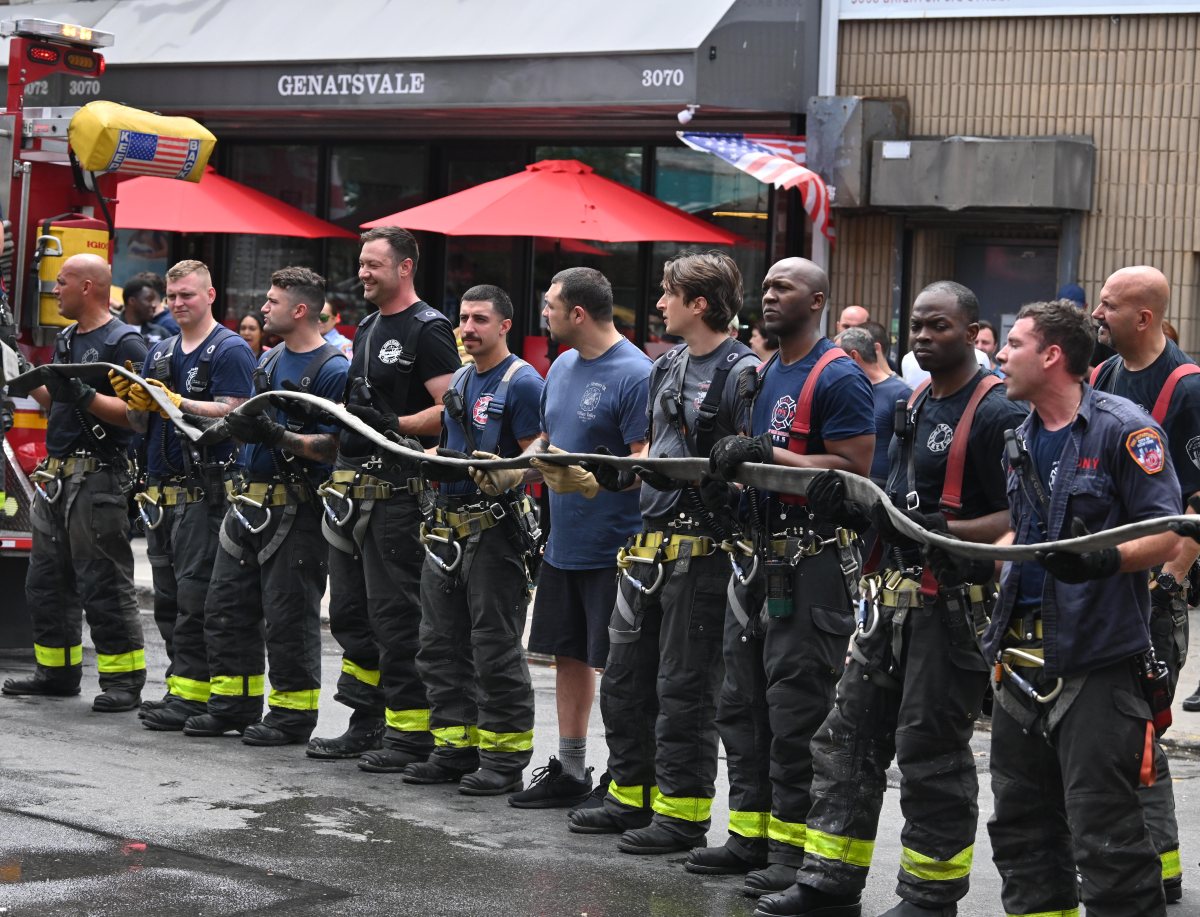 Firefighters repack hose after battling a basement fire in Brighton Beach