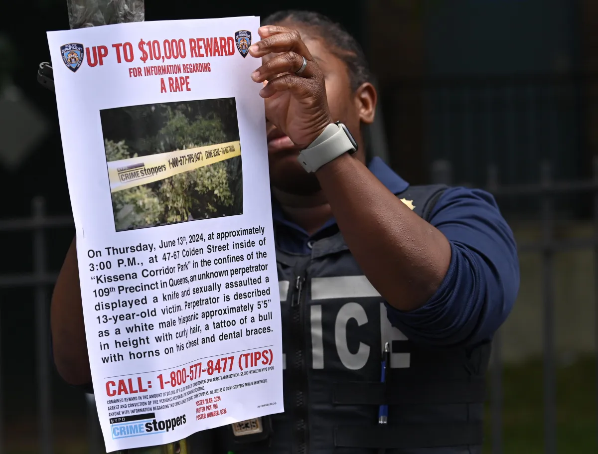 NYPD officer hangs up poster of Queens park rapist case