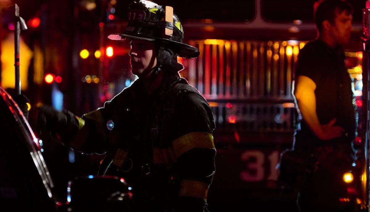 A firefighter takes a rest during a three alarm fire at 298 College Ave