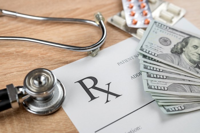 empty rx  doctors prescription with Dollar bill and  stethoscope  on desk.