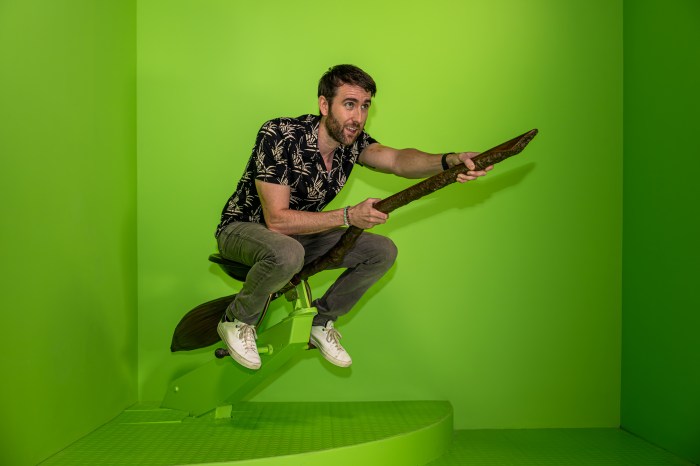 Matthew Lewis trying out the new broomstick adventure at Harry Potter New York.
