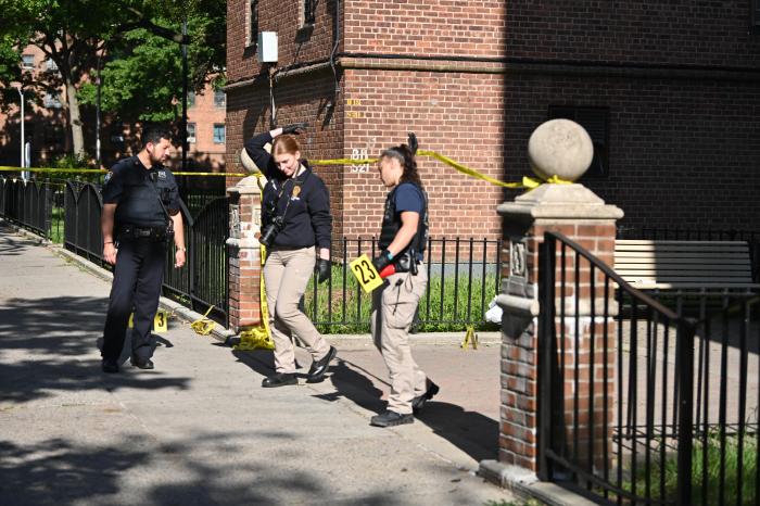 Crime scene detectives cross police line at Brooklyn shooting scene