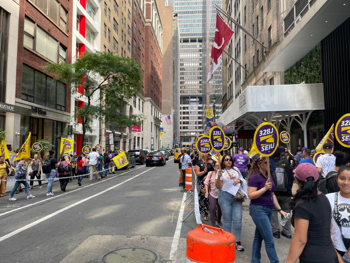 union member rally in the daytime on both sides of a street in Midtown