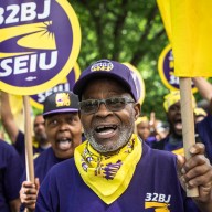 NYC public school cleaners and handyperson rallying outside holding signs that read 32BJ SEIU
