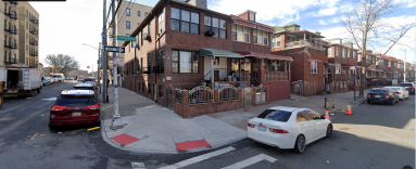 street with a row of houses in the Bronx during the day