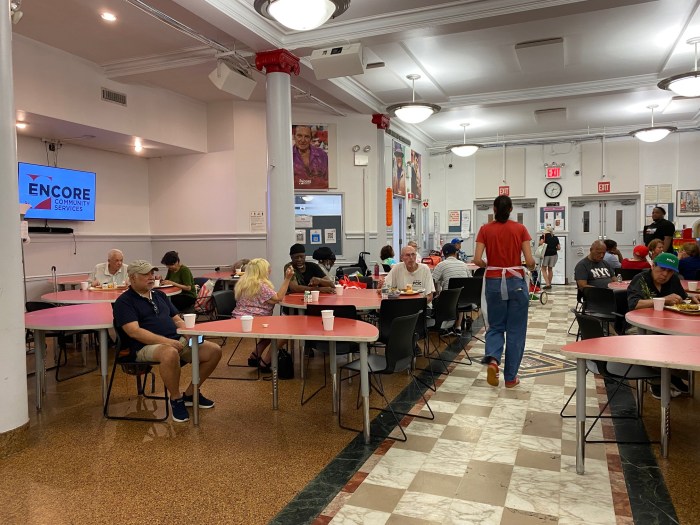 people sitting at tables eating at a Midtown senior center
