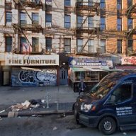 buildings with fire escapes and closed stores in the Bronx