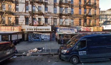 buildings with fire escapes and closed stores in the Bronx