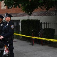 uniformed NYPD outside near police tape in Brooklyn