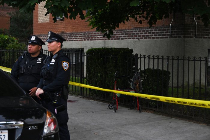 uniformed NYPD outside near police tape in Brooklyn