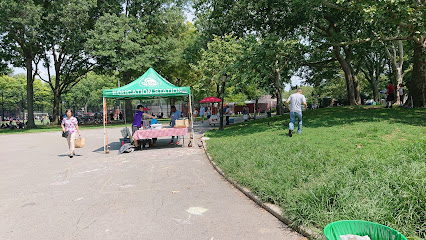 park in Brooklyn with a table and tent set up