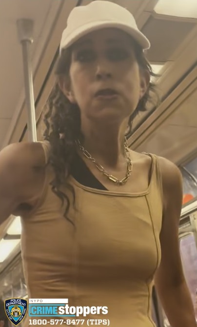 woman on Manhattan train, wearing white hat and tank top