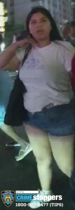 woman wearing white t-shirt and jean shorts wanted for allegedly attacking a police officer in Midtown Manhattan