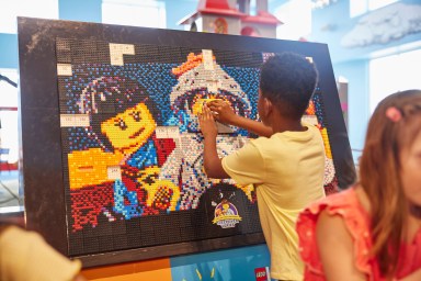 a child building a lego mosaic