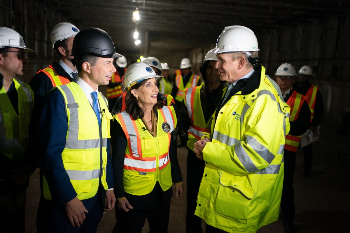 People in hard hats tour Second Avenue Subway extension site