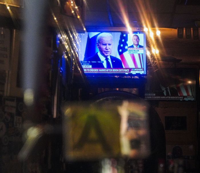 TV screen in New York showing news of President Biden dropping out of race