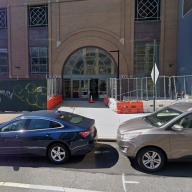 building in Downtown Brooklyn with cars parked in front