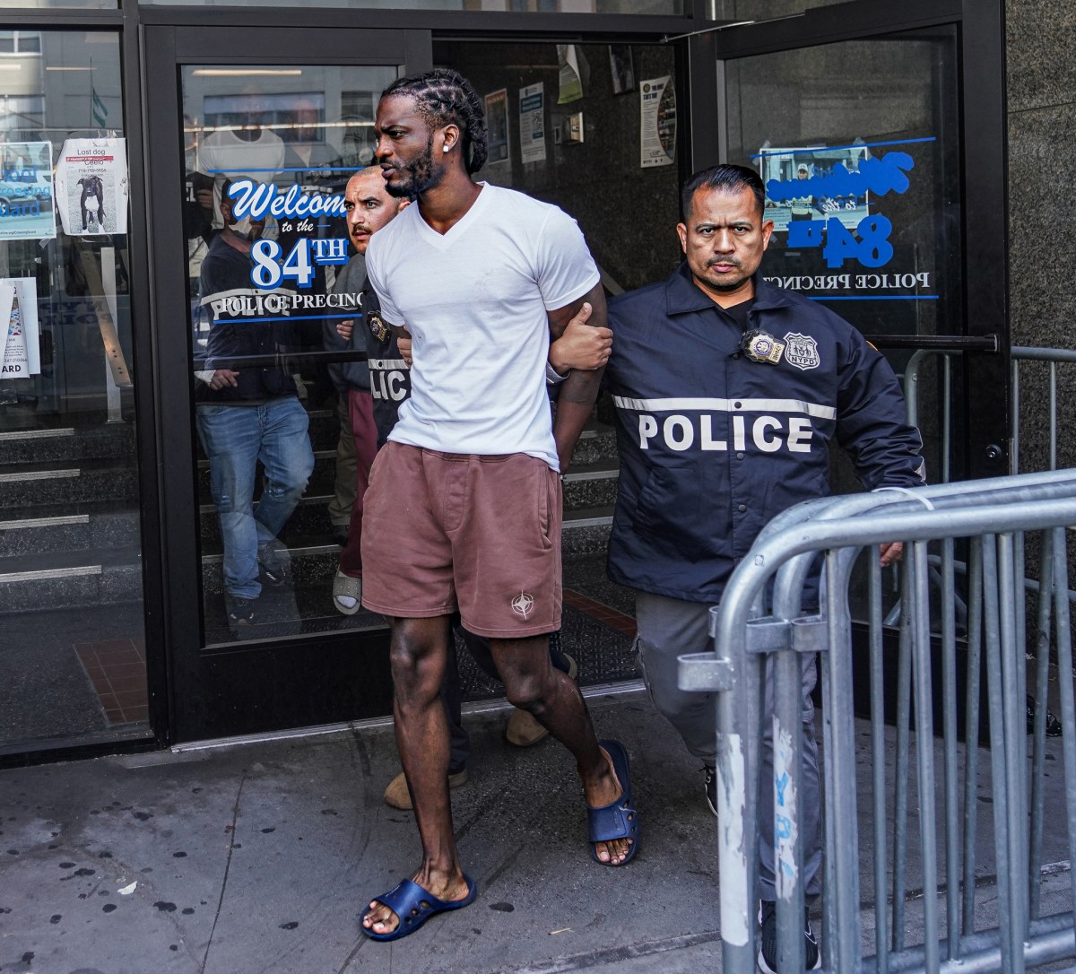 The group were whisked away in cuffs to 84th Precinct where all five alleged scam artists were piled into unmarked police vans.