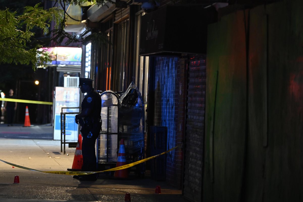 Brooklyn police officer stands guard at scene where man was shot